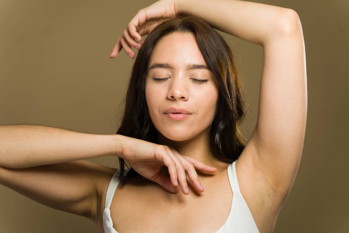 Woman posing confidently after dermal fillers body sculpting treatment showing smooth skin and natural contours.
